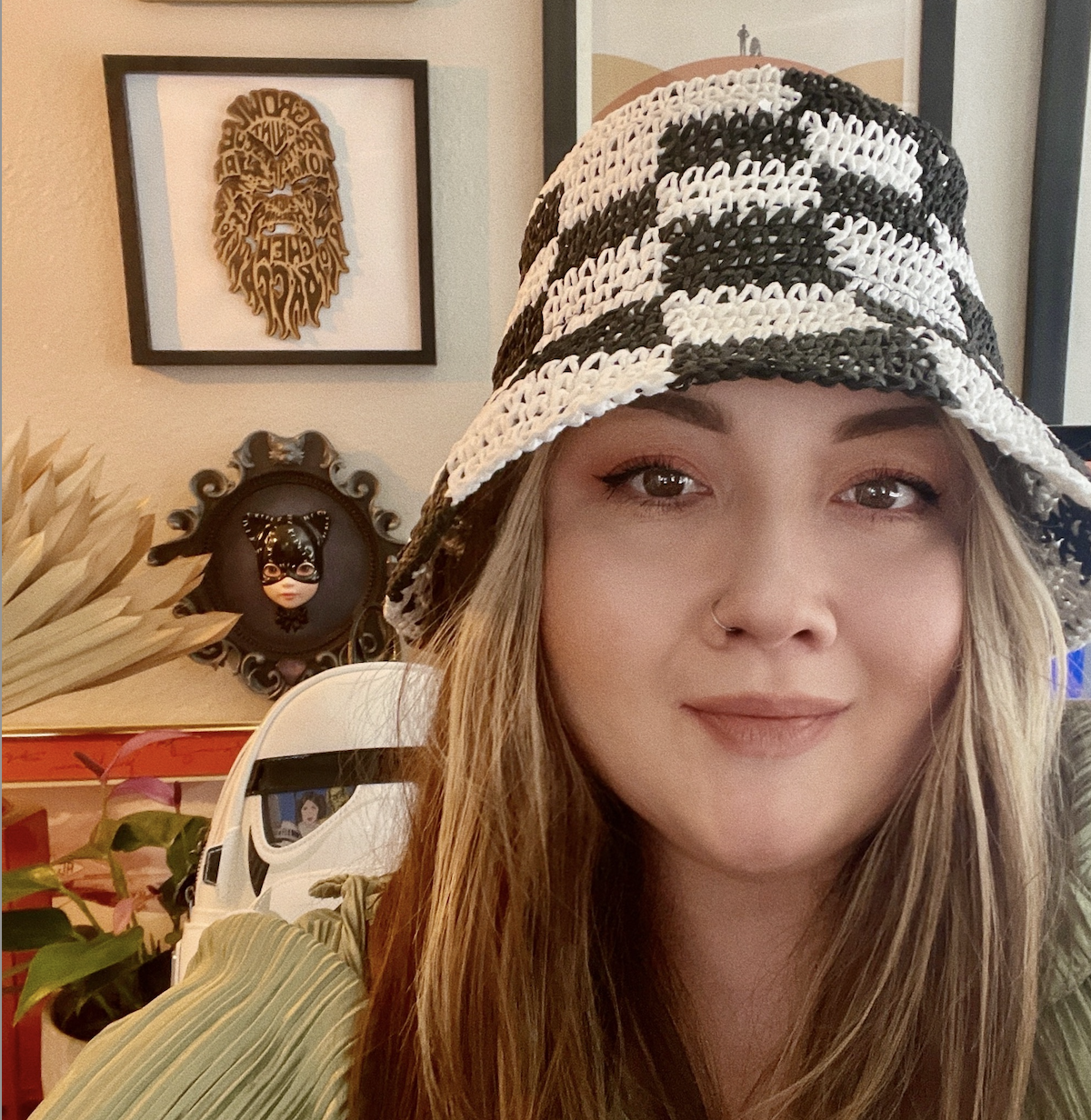 Selfie of a brunette woman with a black and white checkered hat